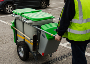 Double Space-Liner™ Orderly Barrow for street cleaning with green moulding and lids, being pushed in car park