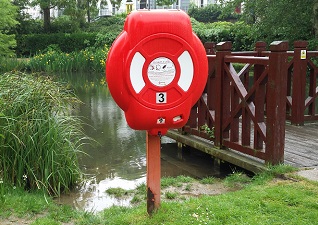 Guardian™ Lifebuoy Housing by lake, surrounded by grassy area and jeti
