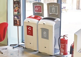 Nexus® 100 Indoor Recycling Bins for cans and general waste next to leaflet stand