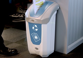 Nexus® 30 Confidential Paper Recycling Bin with pastel blue paper aperture slot with lock and confidential paper graphics and paper being inserted