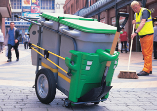 Double Space-Liner™ Orderly Barrow in grey with green moulding and lid with spade and man cleaning town centre with broom
