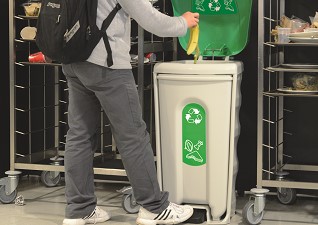Nexus® Shuttle Food Waste Catering Bin with foot-operated pedal with student disposing of banana skin