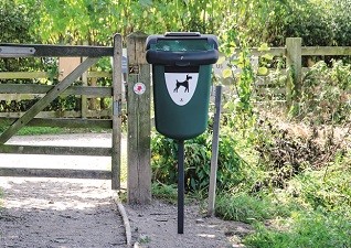 Retriever™ 35 Pet Waste Station in deep green on rural lane post mounted